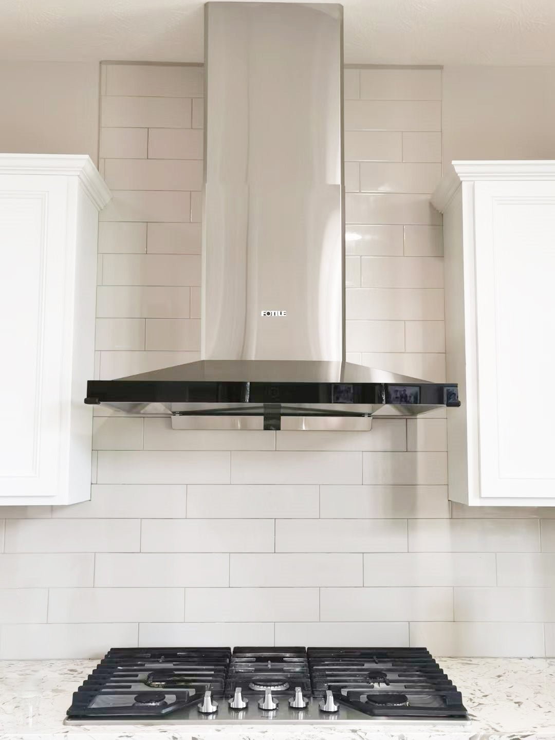 Stainless steel decorative range hood ceiling cover with chimney body, wall-mounted view.