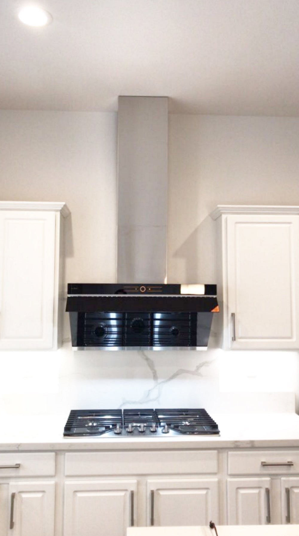Stainless steel ceiling vent cover chimney installed above cooktop