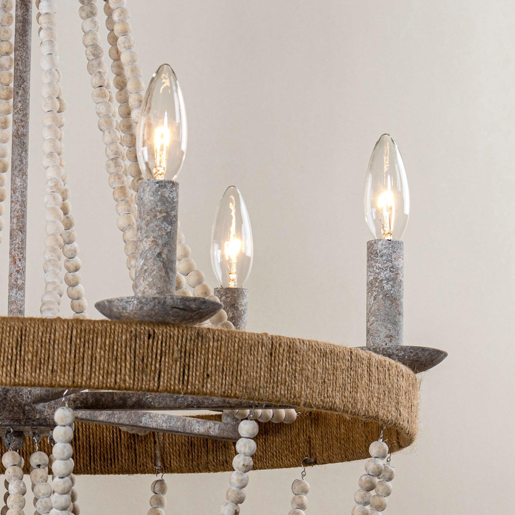 Close-up of 6 candle-style bulbs with gray sockets on a rustic round wood-bead frame