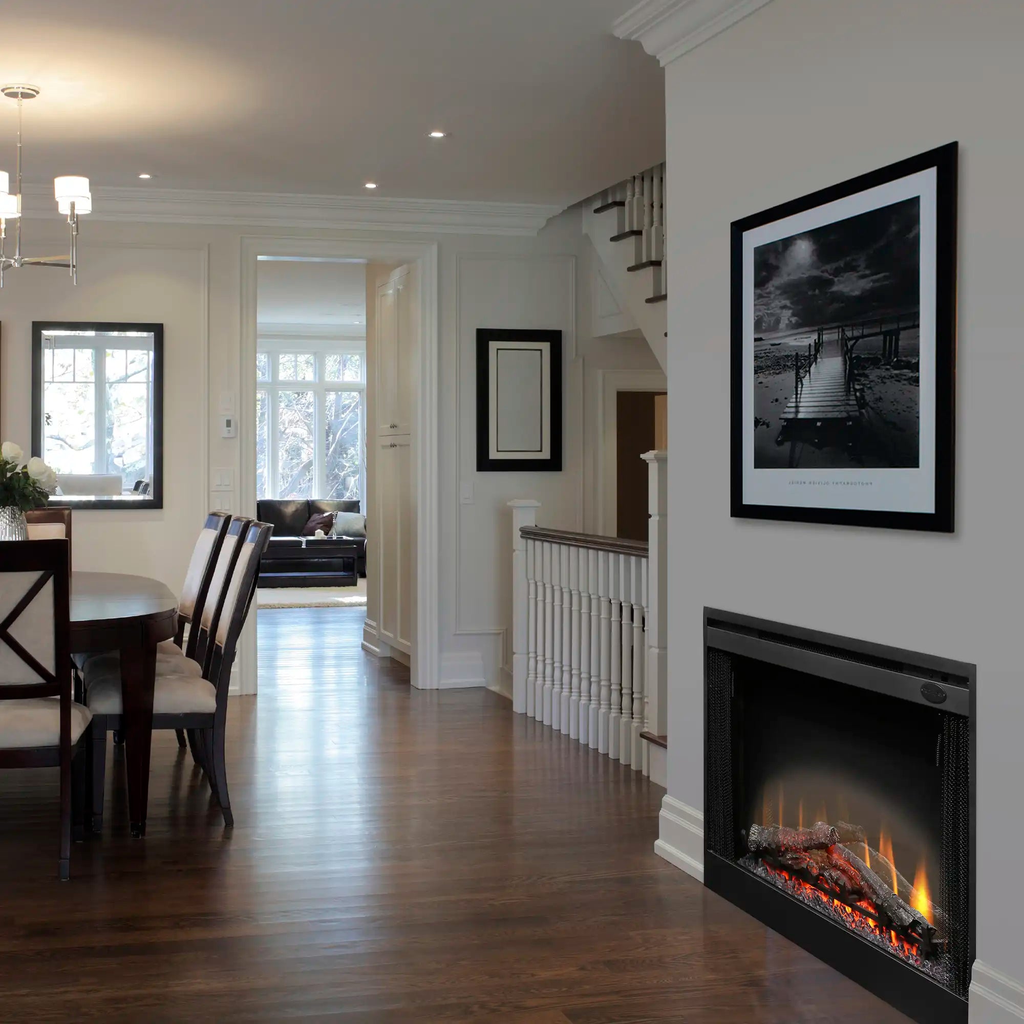 Black electric fireplace insert with glass front, flames and embers visible