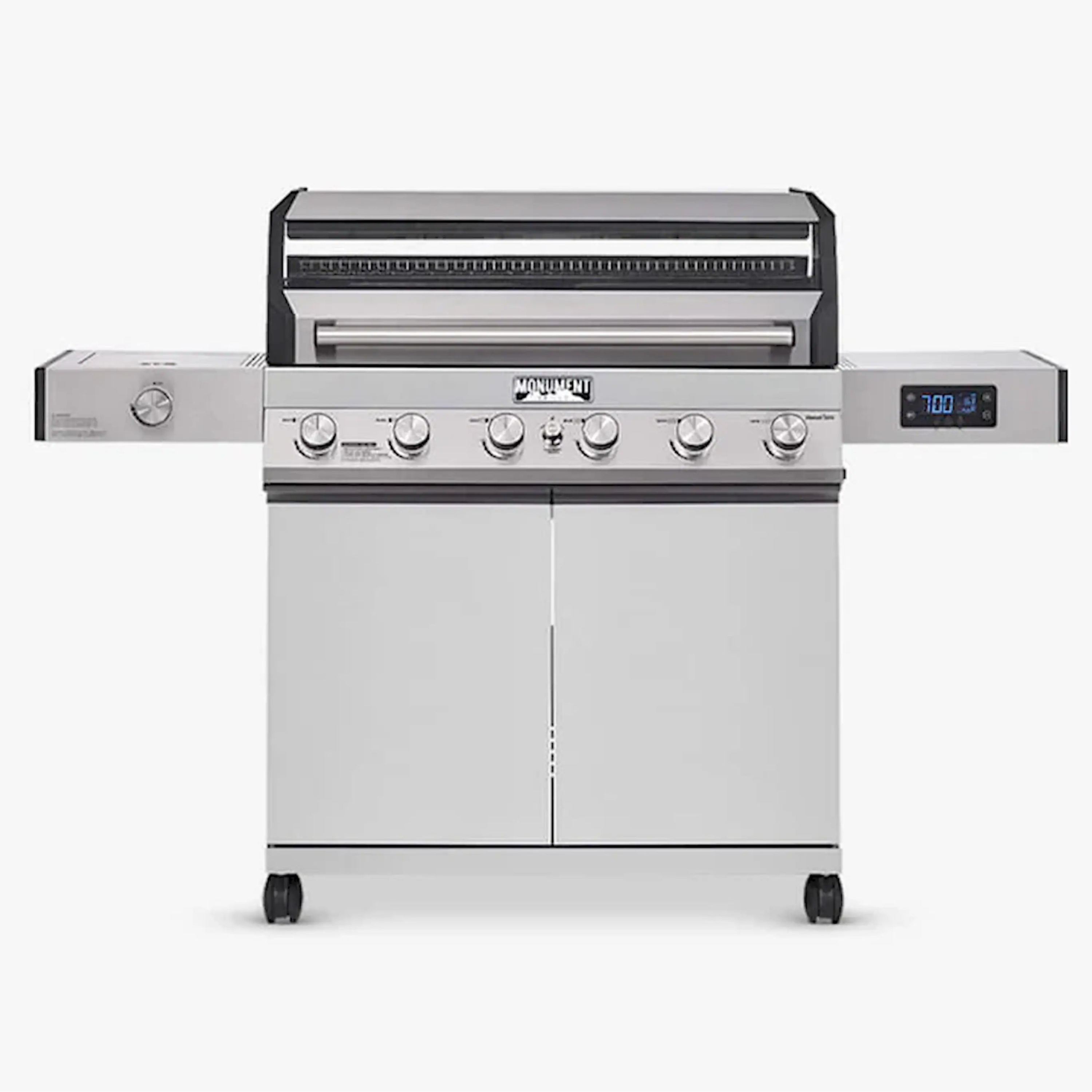 Stainless steel Monument gas grill with lid closed, six burner control dials