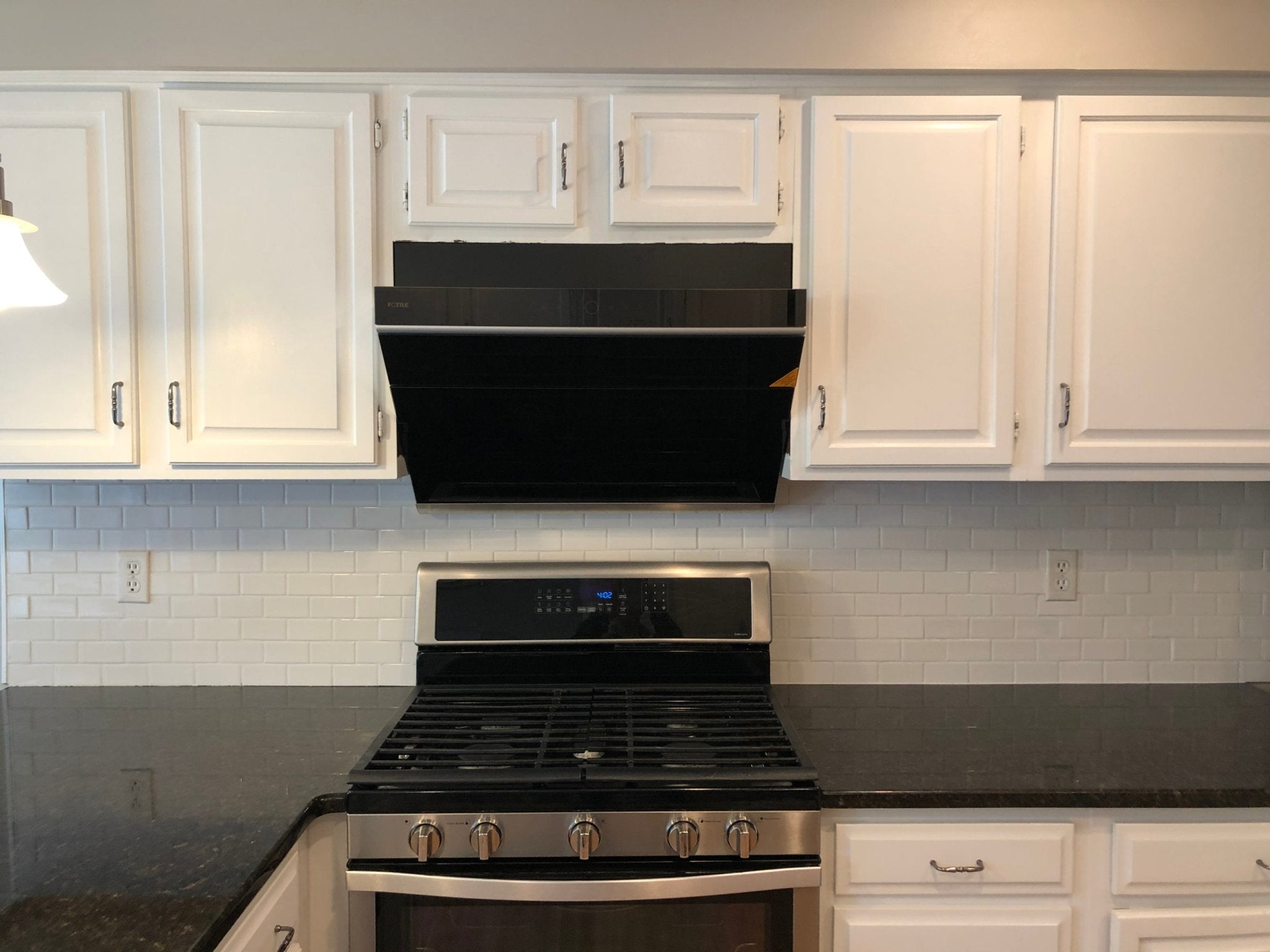 Black decorative vent panel for a slant range hood, flush rectangular design