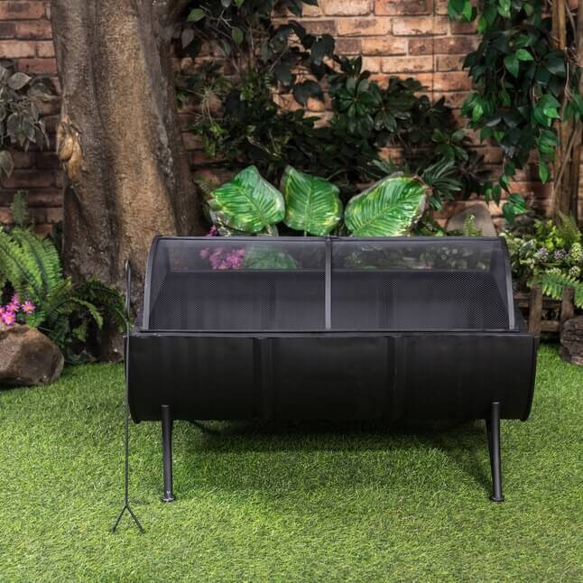 Black barrel wood burner firepit with legs and clear front mesh spark screen