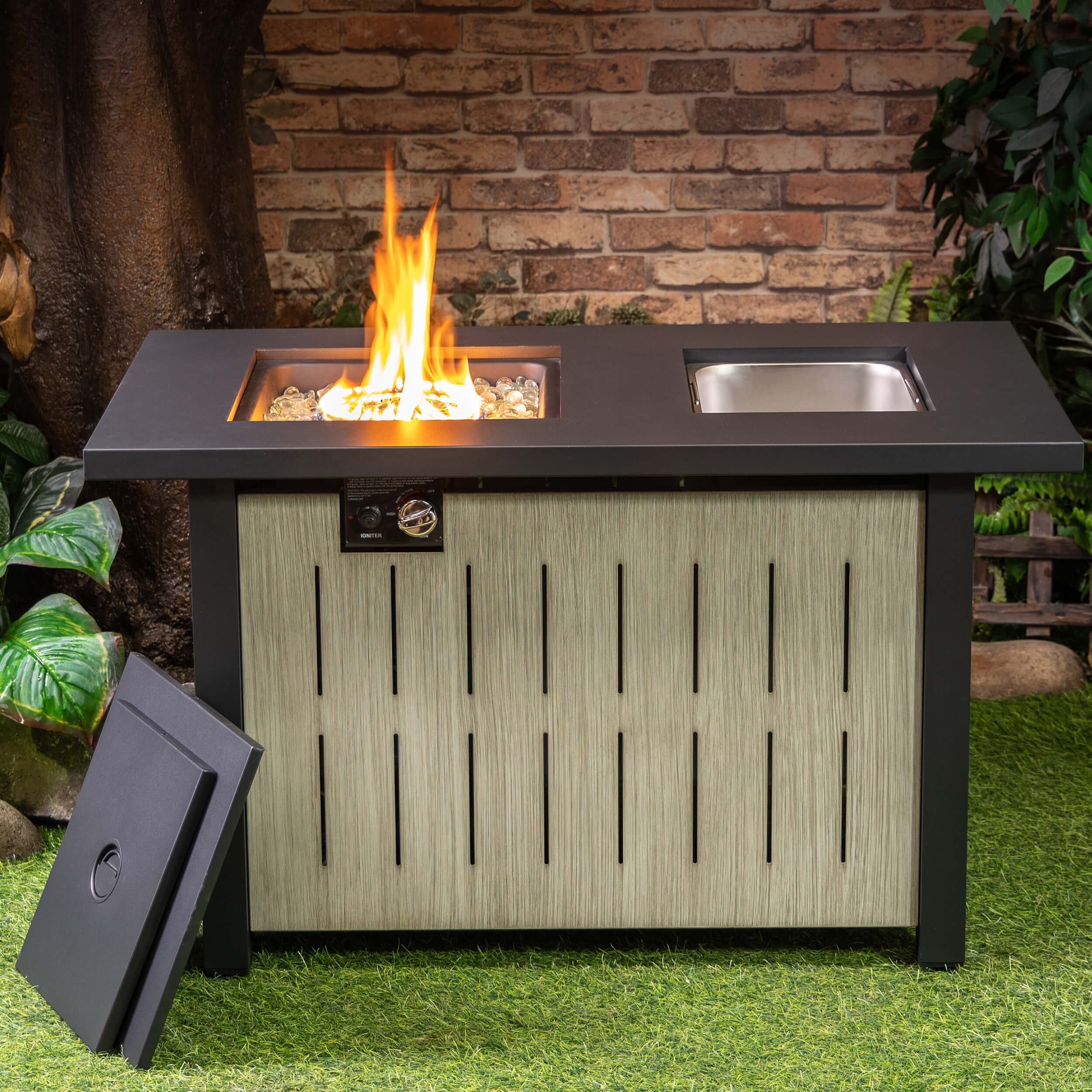 Outdoor firetable showing flames in center and silver ice bucket on the side