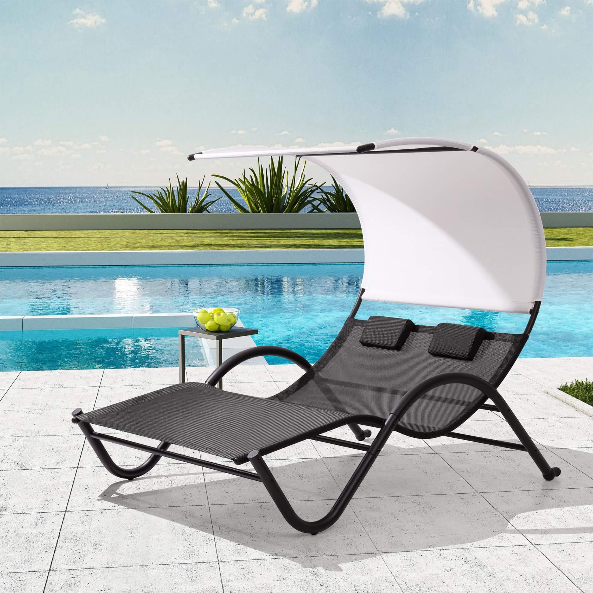Outdoor patio lounge daybed with canopy, white canopy and dark gray cushions