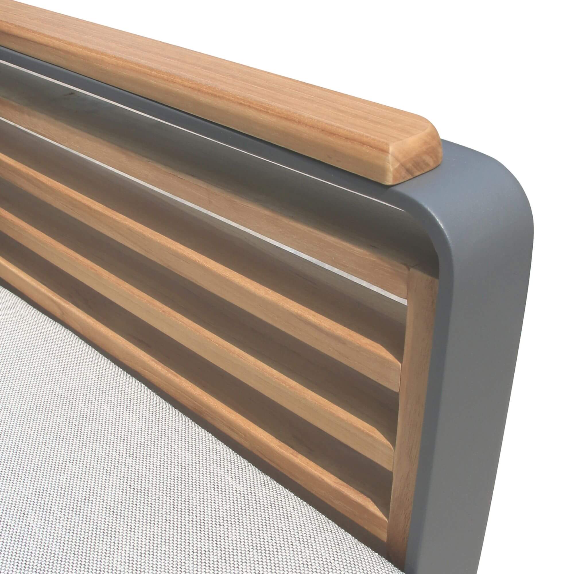 Close-up of slatted wood chair back with dark gray frame and upholstered cushion edge