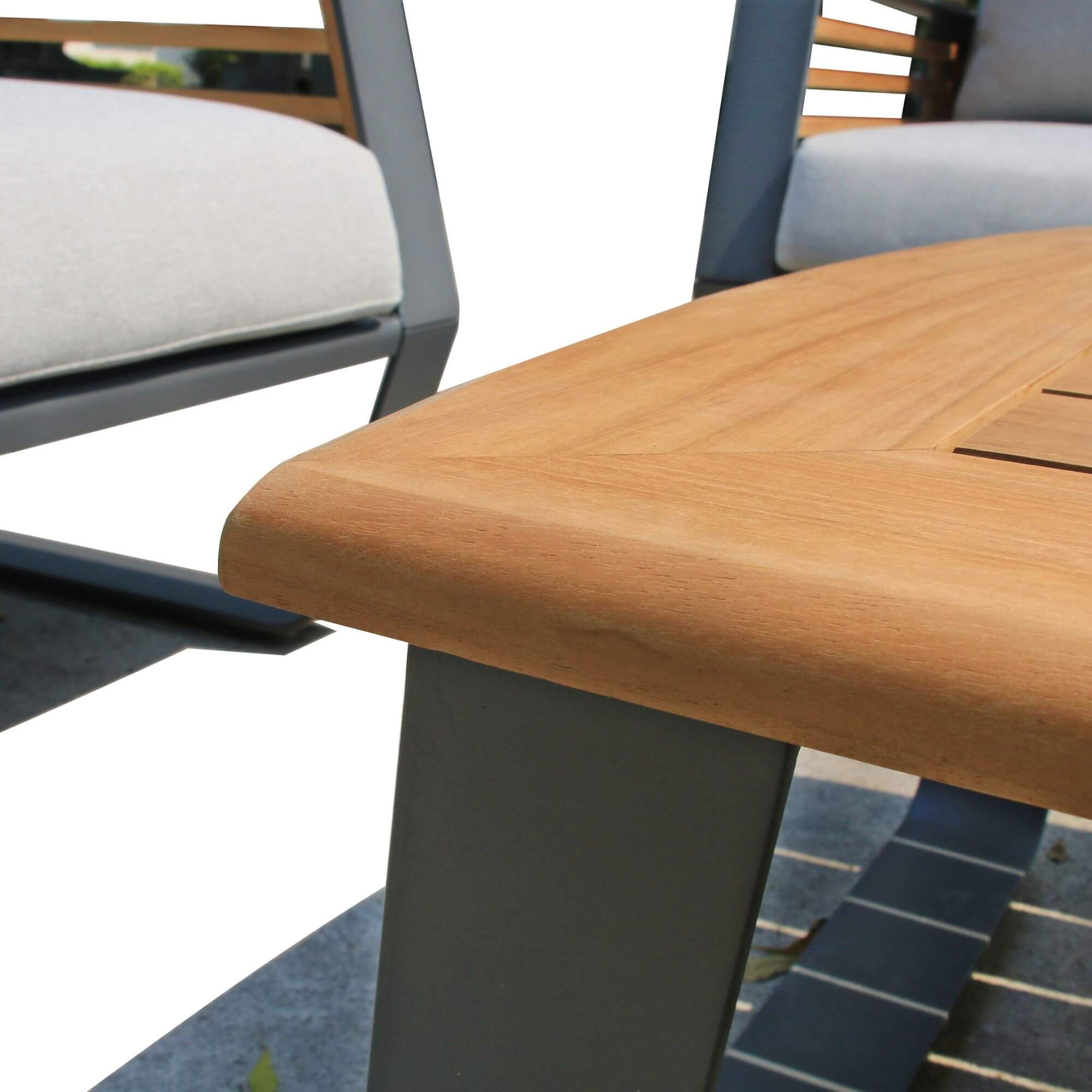 Close-up of warm wood tabletop with dark metal pedestal base for outdoor coffee table