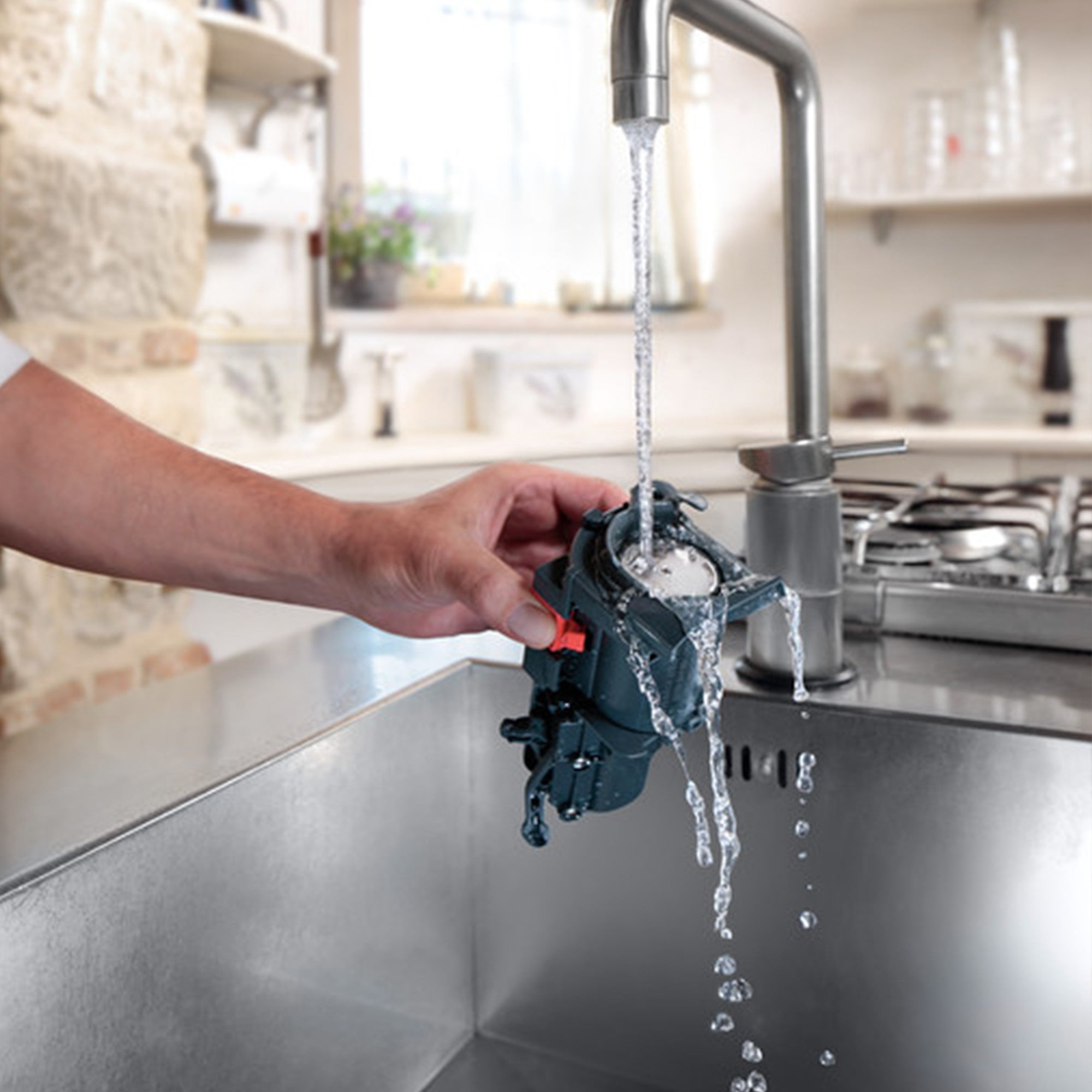 Water spout dispensing water from De'Longhi espresso machine into a sink