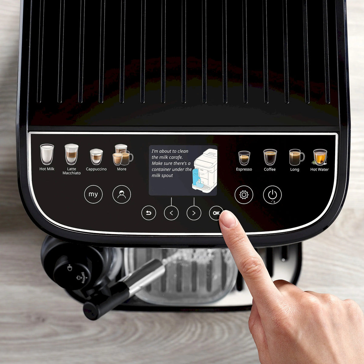 Espresso machine front touchscreen with user icons and fingertip selection, black panel.