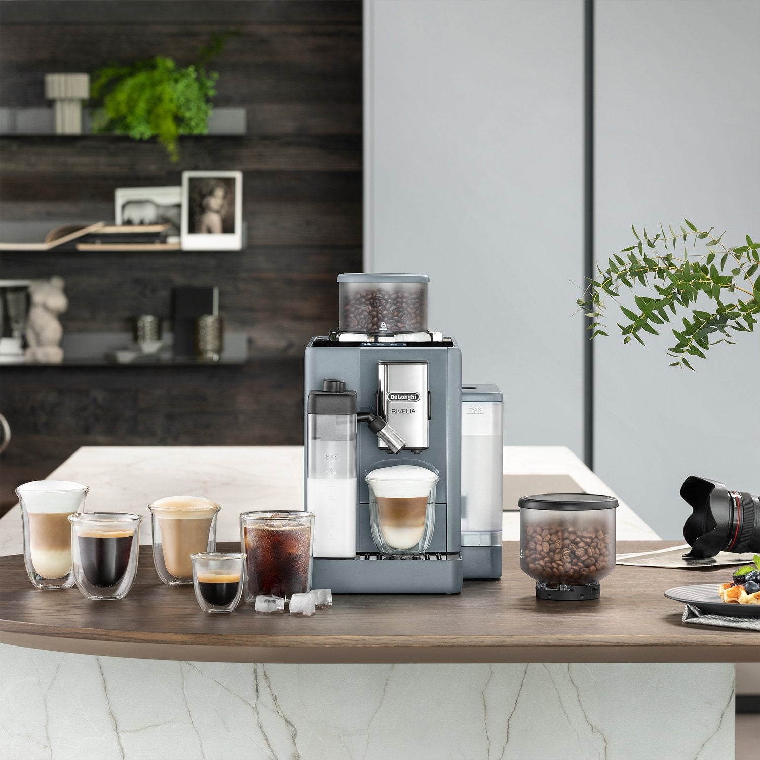 De'Longhi Rivelia fully automatic espresso machine in pebble gray with bean hopper and cups