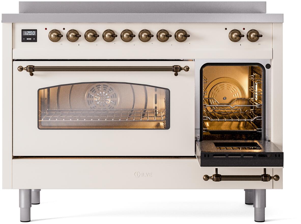 Freestanding electric induction range with right oven door open, warm lit oven interior