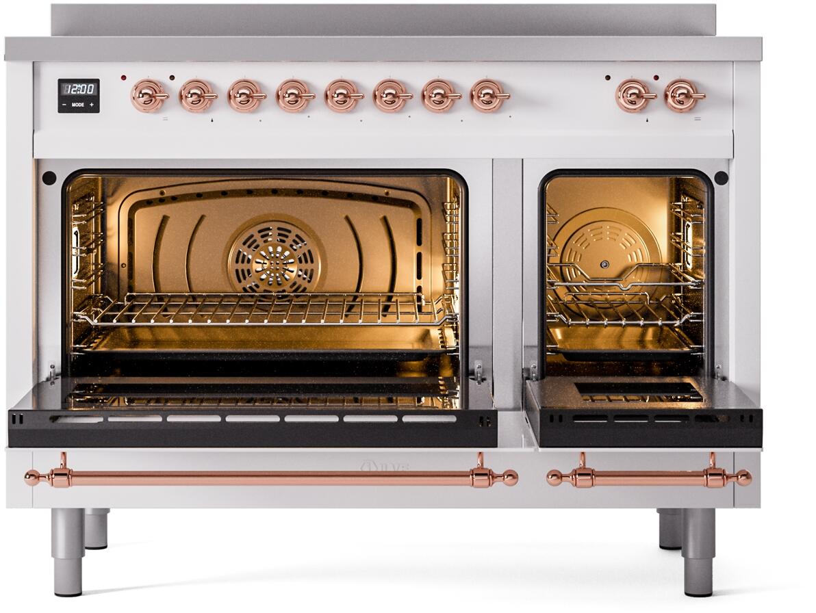 White induction range with illuminated oven cavities and copper trim handles