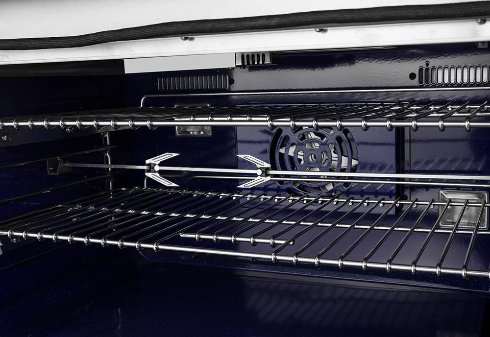 Open oven interior with metal racks and heating elements on stainless dual-fuel range