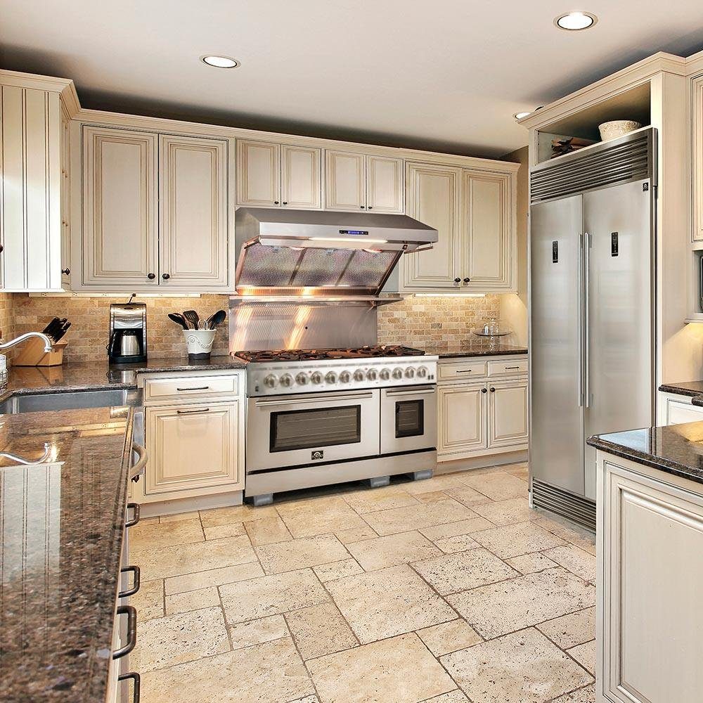 Stainless steel dual-fuel range with vent hood in built-in kitchen setup