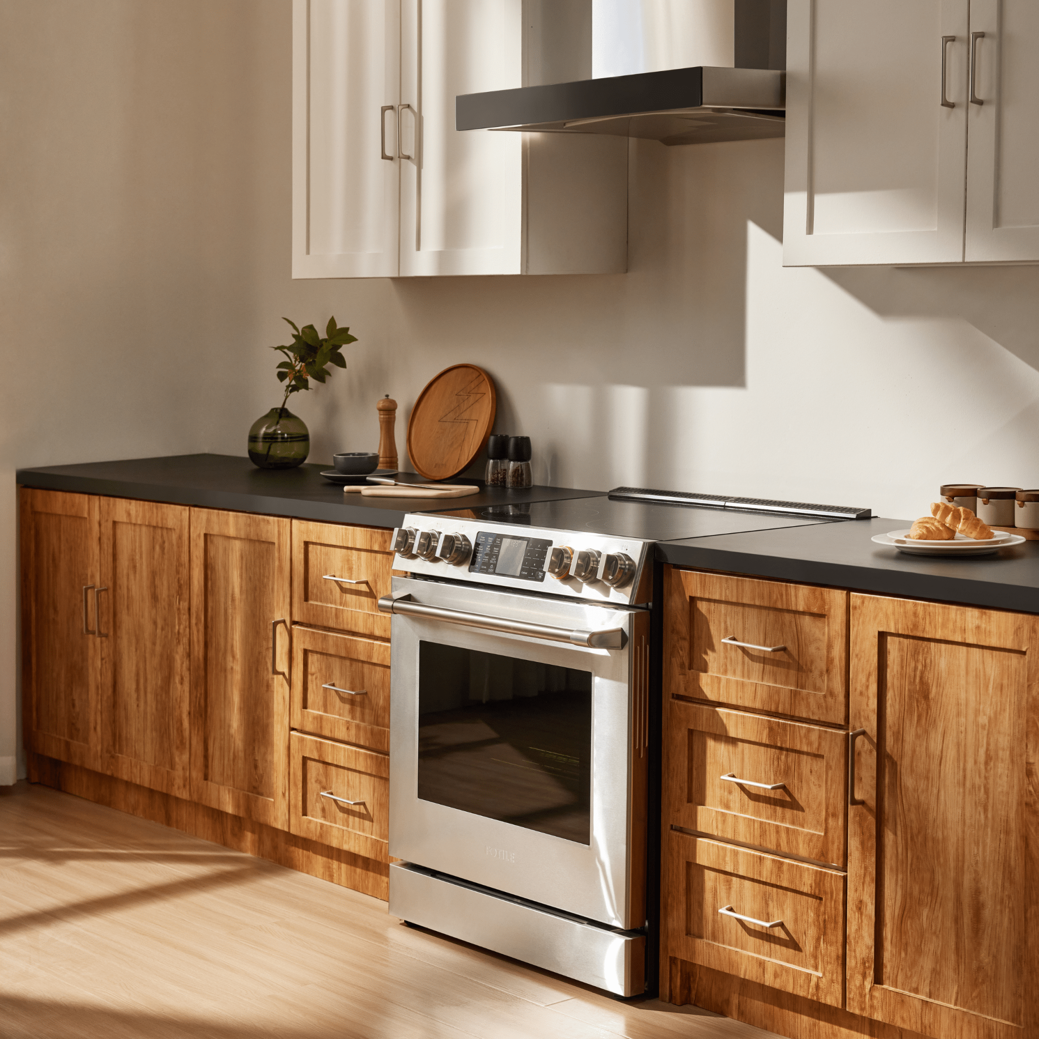 Stainless steel electric slide-in range with cooktop and closed oven door in kitchen