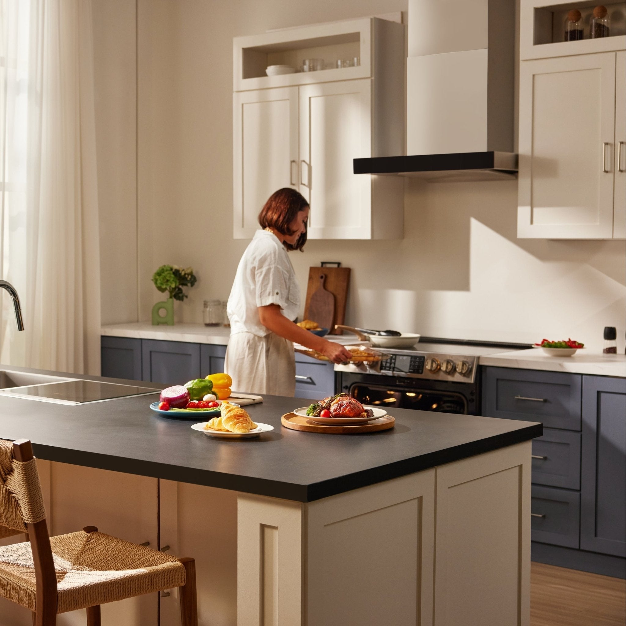 Stainless slide-in electric range with cooktop burners and cookware ready for cooking