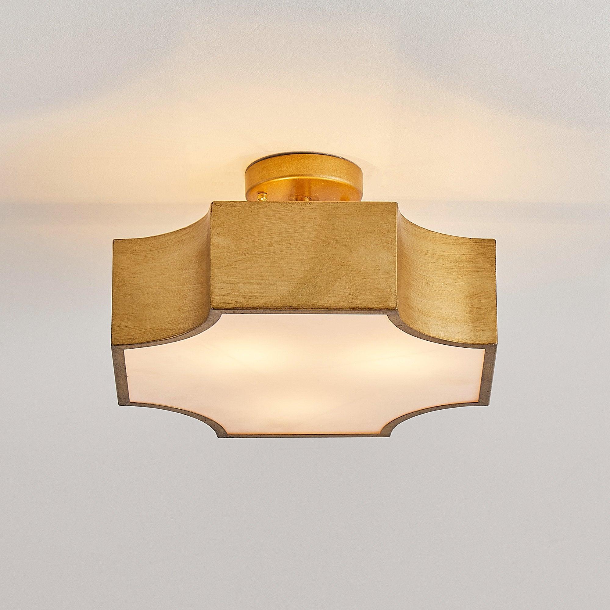 Front view of brushed gold semi-flush mount with textured shade panels and frosted diffuser