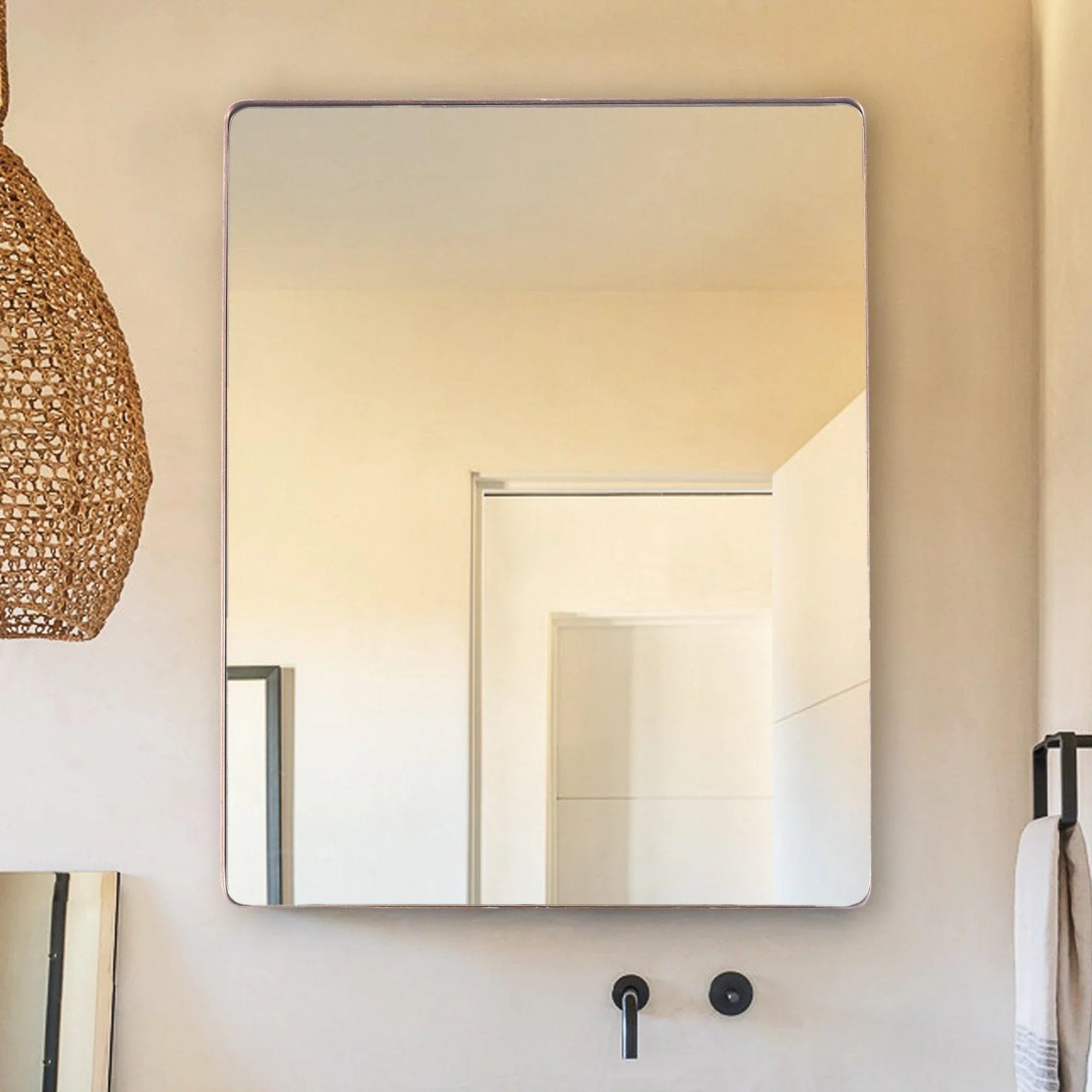 Square wall mirror with gold-toned frame and rounded corners, flat reflective panel
