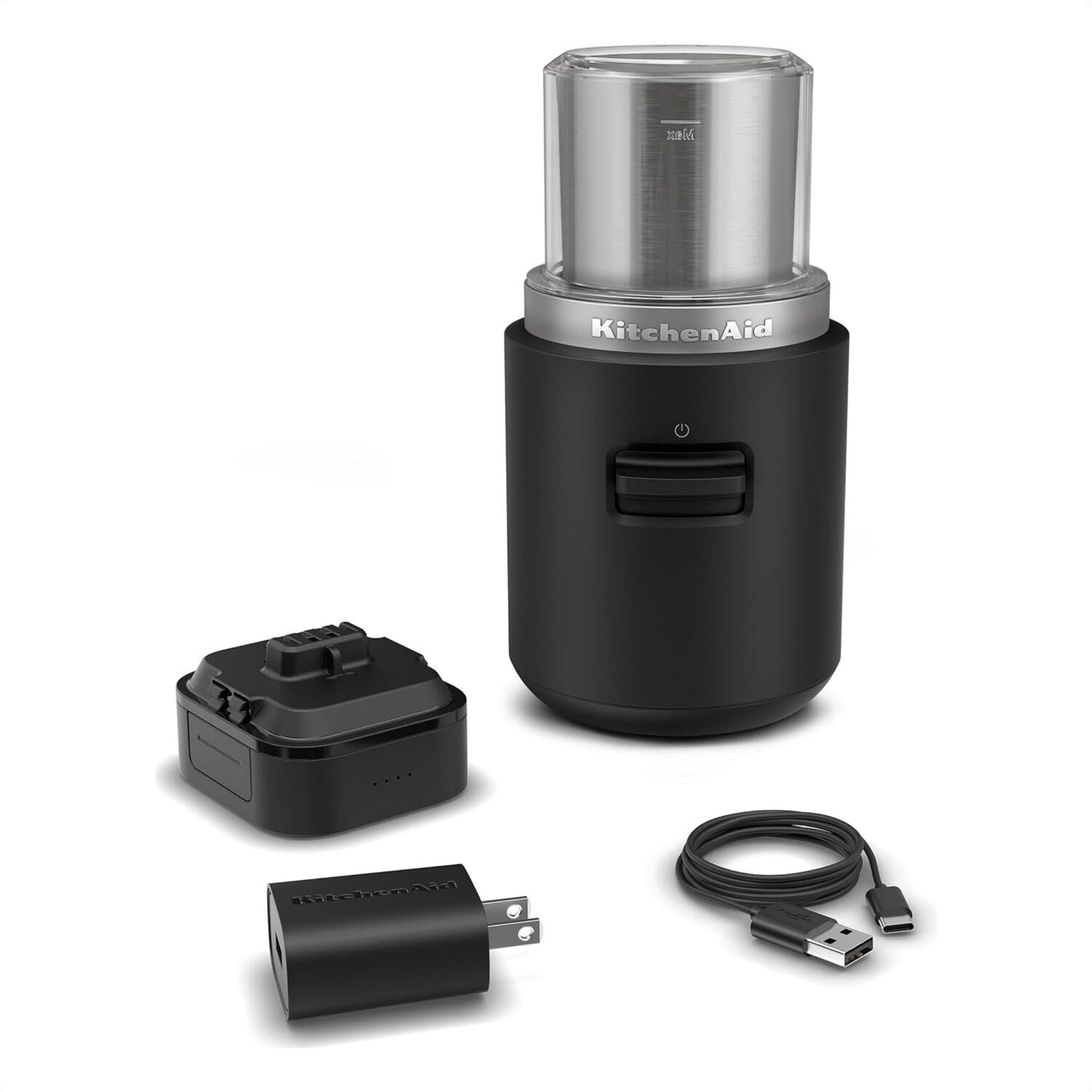 Black matte cordless coffee grinder with stainless top, removable battery, and USB cable