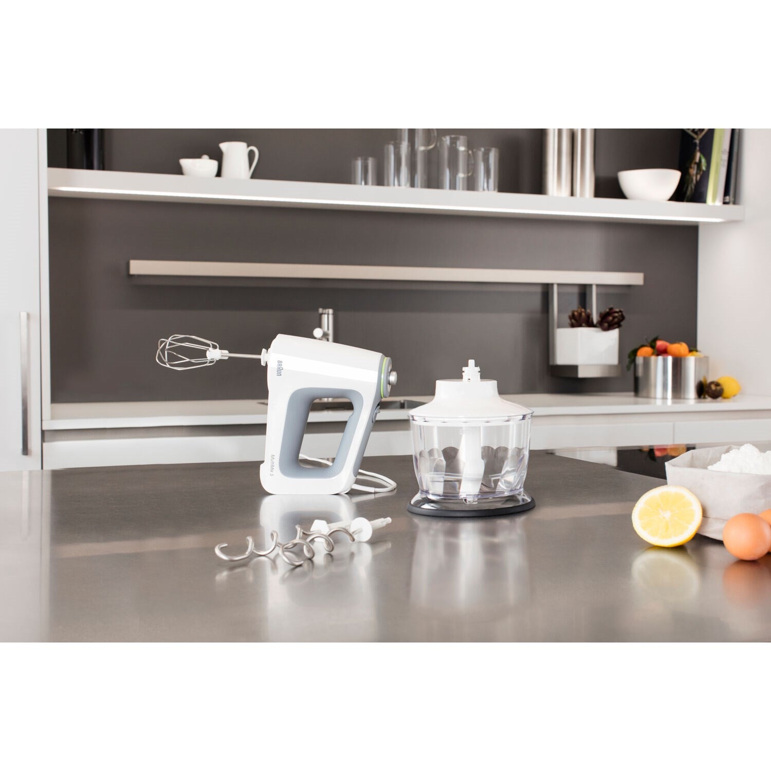 White hand mixer with whisk attachment and clear chopping bowl
