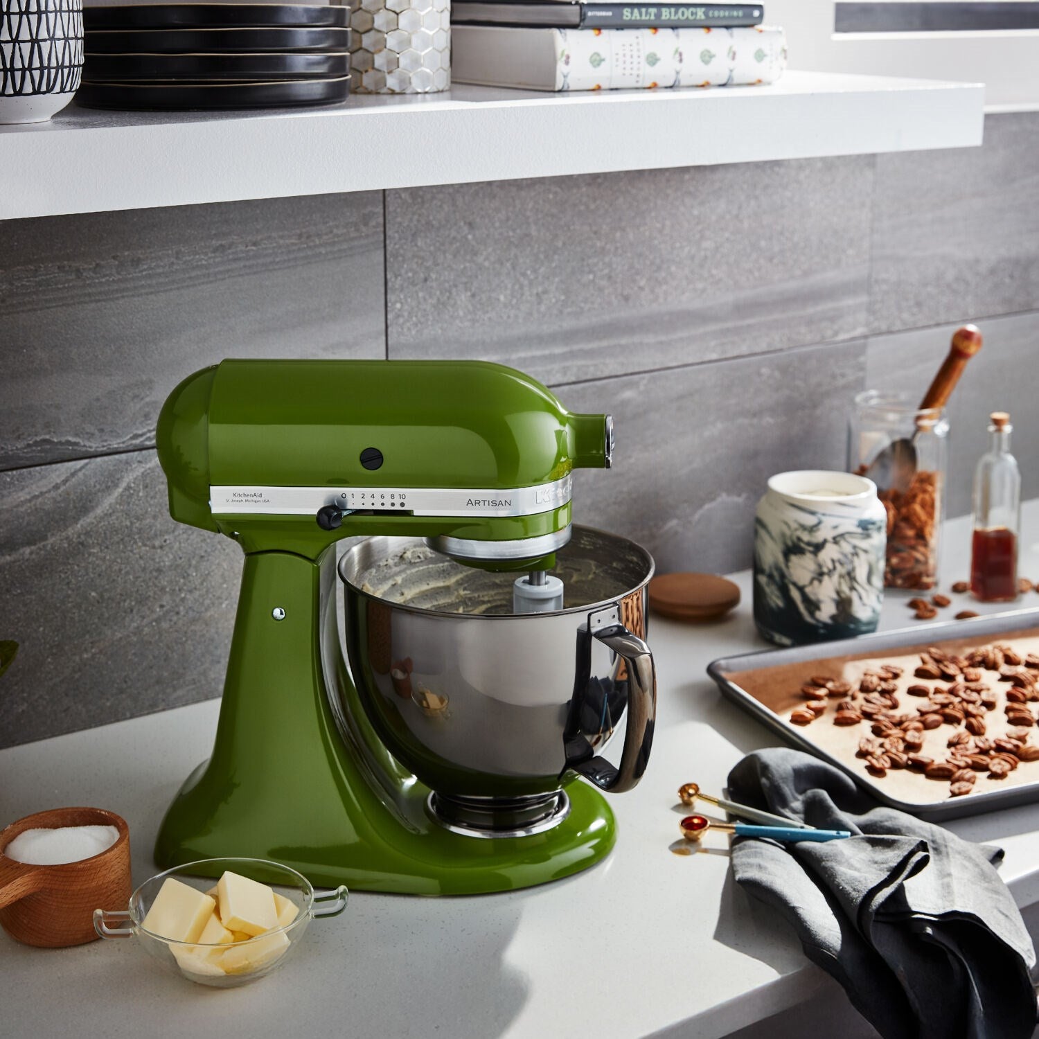 Matcha green tilt-head stand mixer with stainless bowl on a countertop