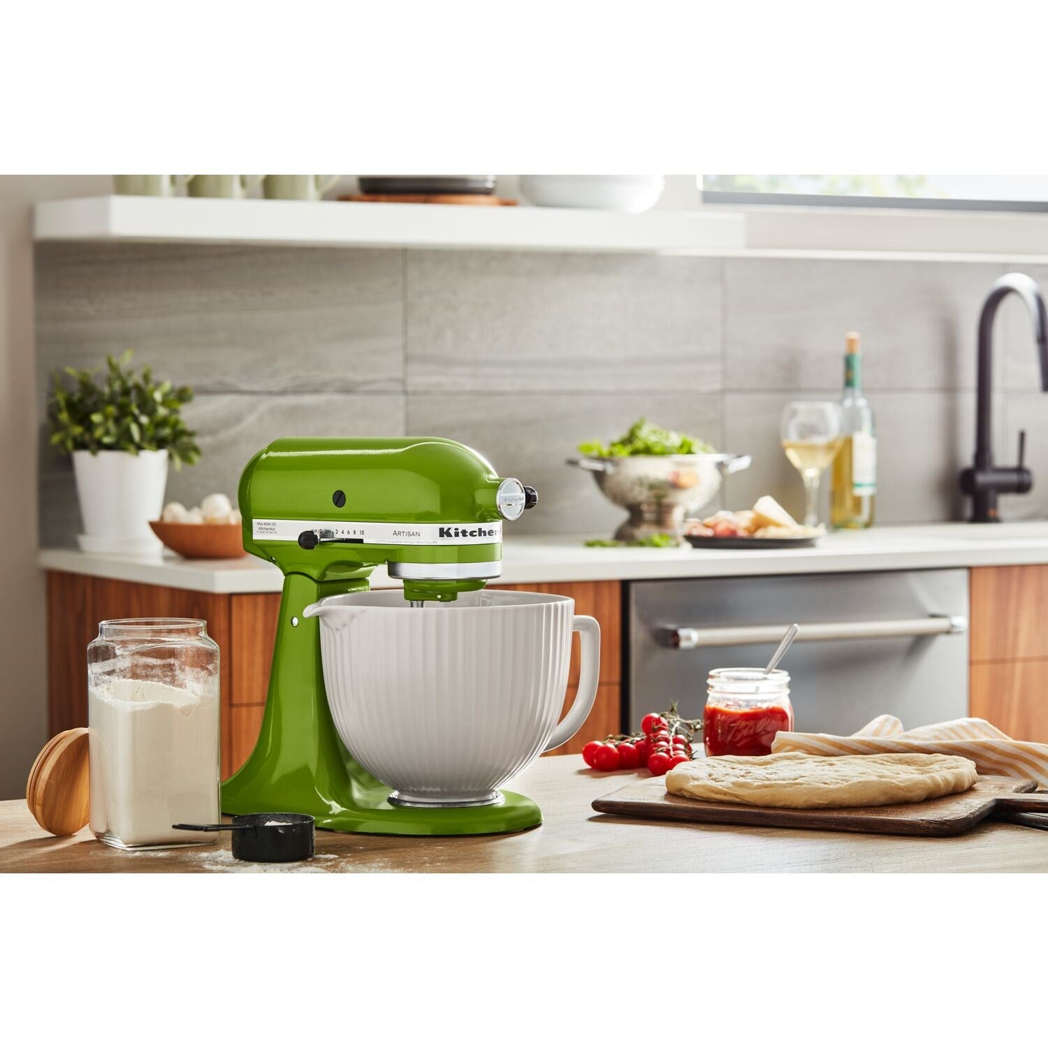 White ceramic mixing bowl on countertop, ribbed sides and side handle