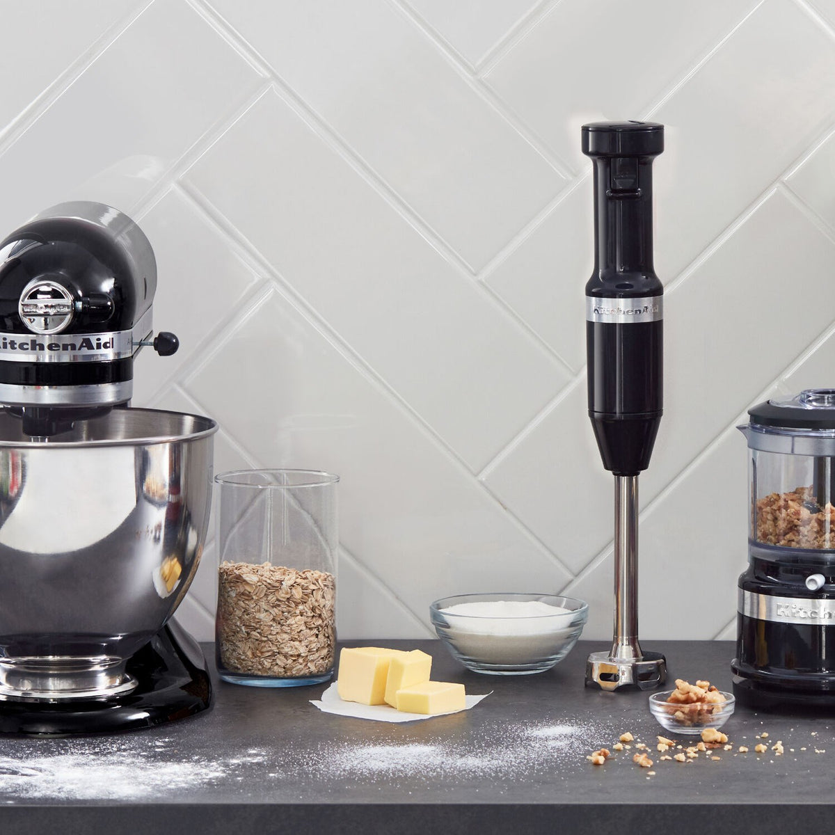 Onyx black immersion blender with blending cup and ingredients on countertop