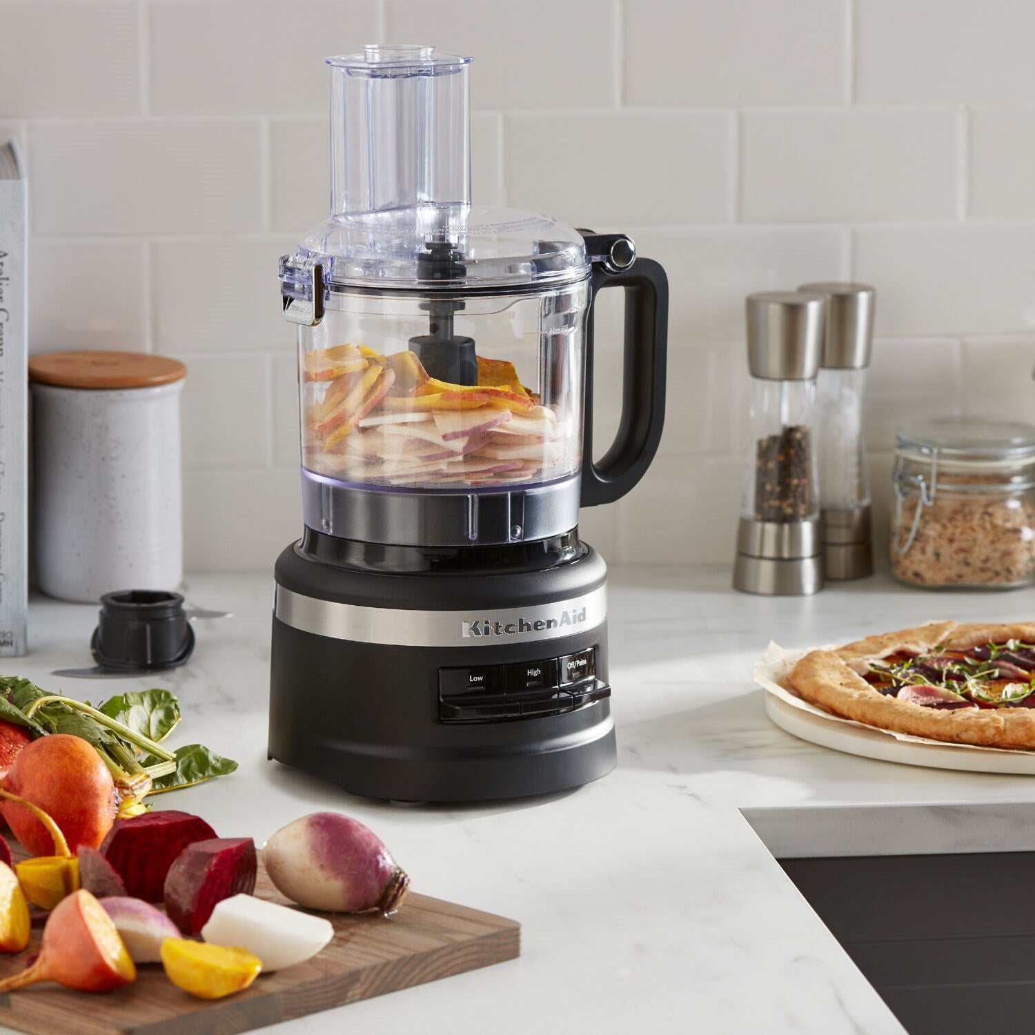 Black matte food processor with clear bowl and slicing/shredding insert