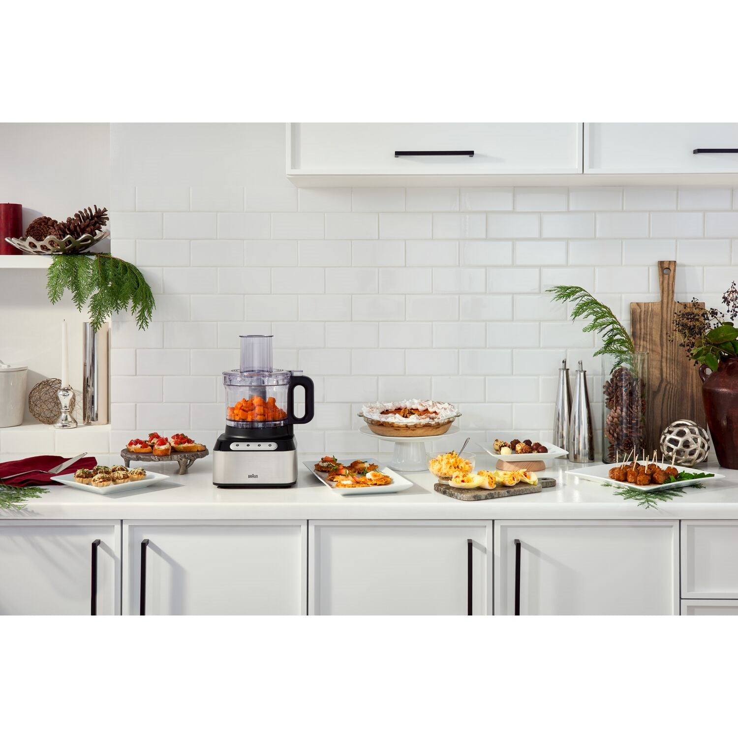 Braun food processor on kitchen counter with prepared foods and blender jar