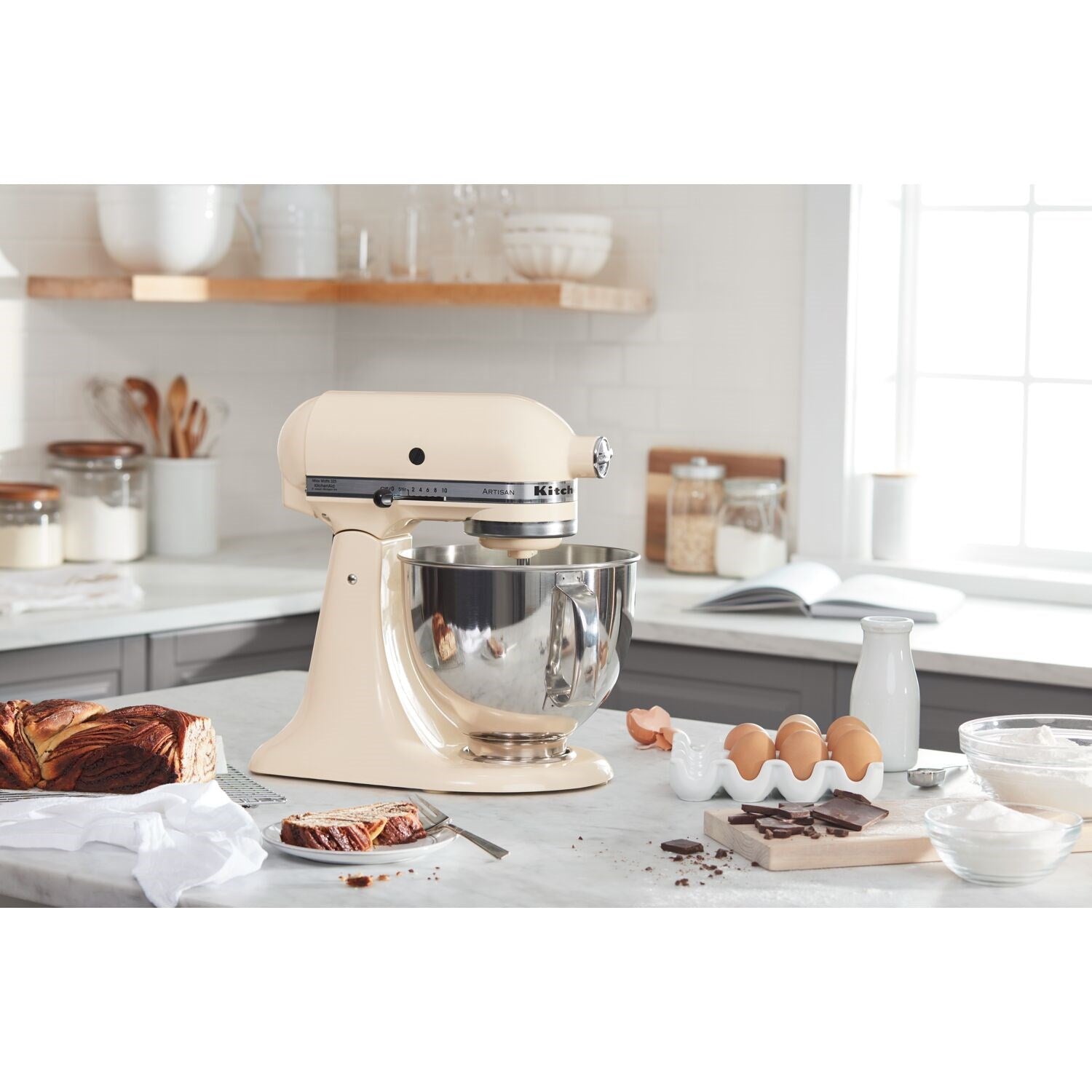 Almond cream tilt-head stand mixer with stainless bowl and wire whisk attachment