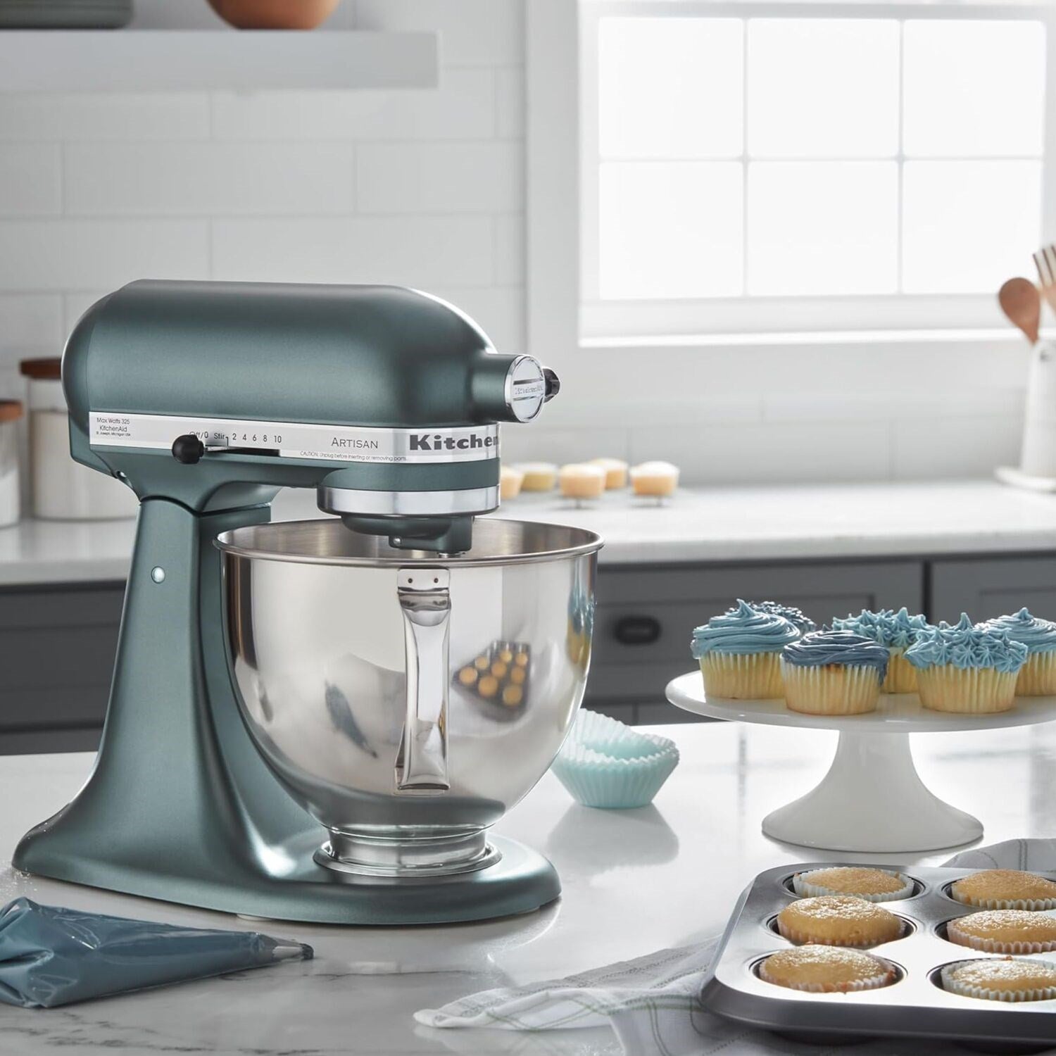 Juniper tilt-head stand mixer in kitchen setting with stainless bowl and cupcake batter tools