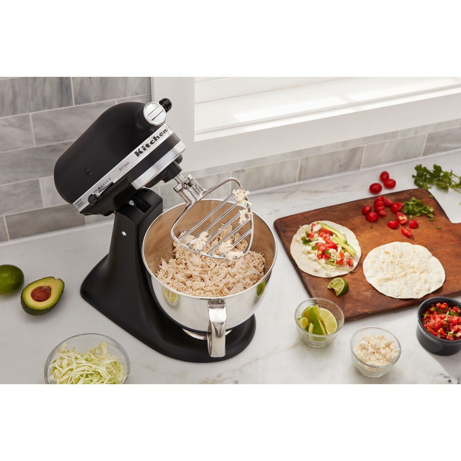 Stainless steel pastry beater attachment shown in use with a stand mixer