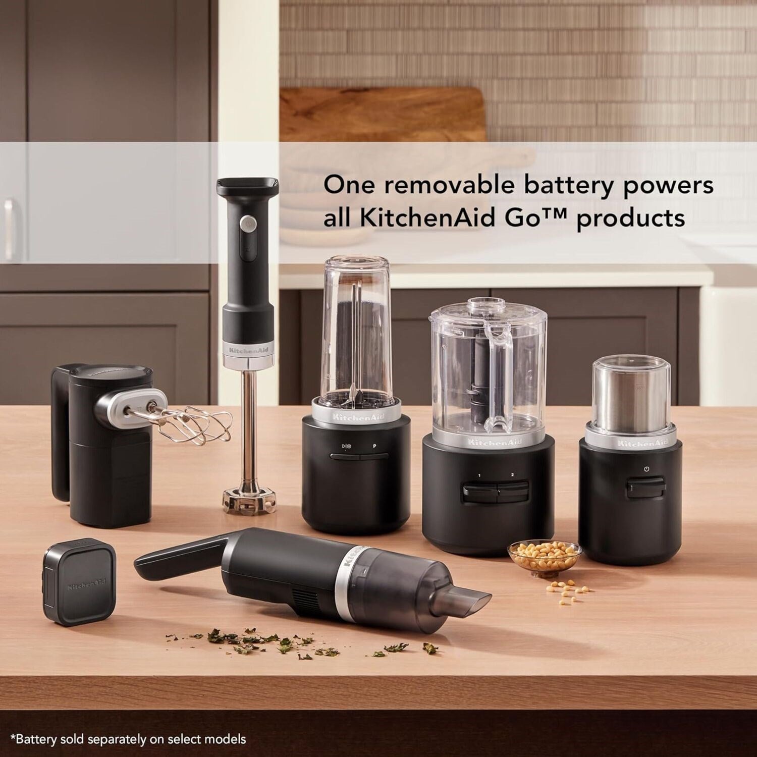 Black matte cordless blade coffee grinder with clear cup, stainless top, and removable battery base