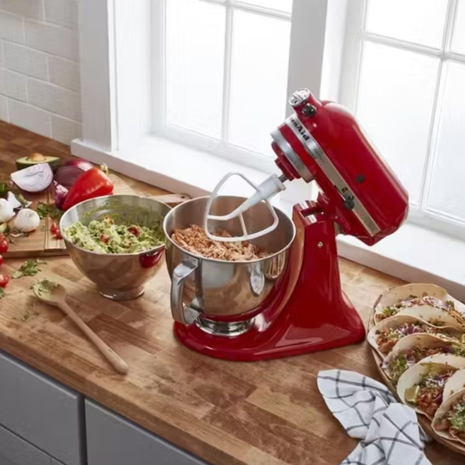 Empire red KitchenAid stand mixer with metal mixing bowl and whisk/beat accessories