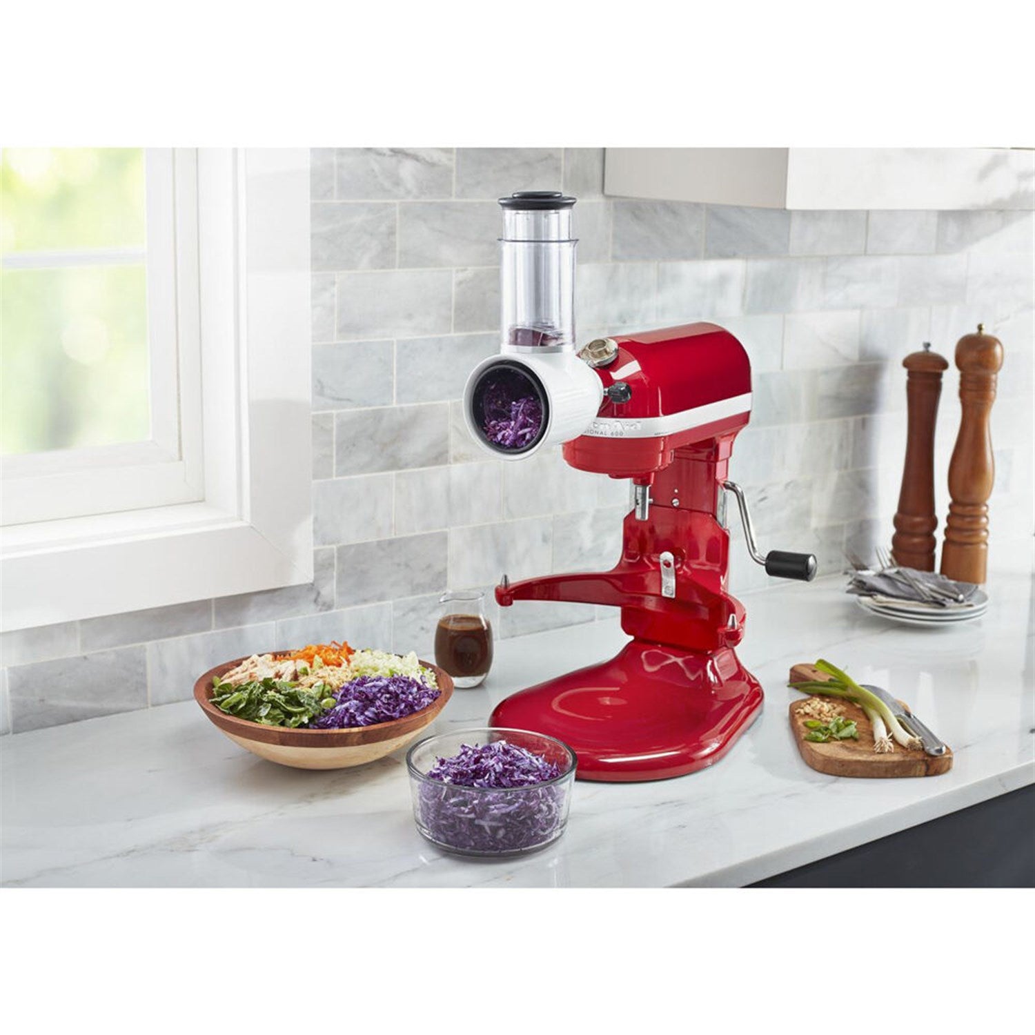 KitchenAid Fresh Prep slicer/shredder attachment with purple cabbage in chute and bowls