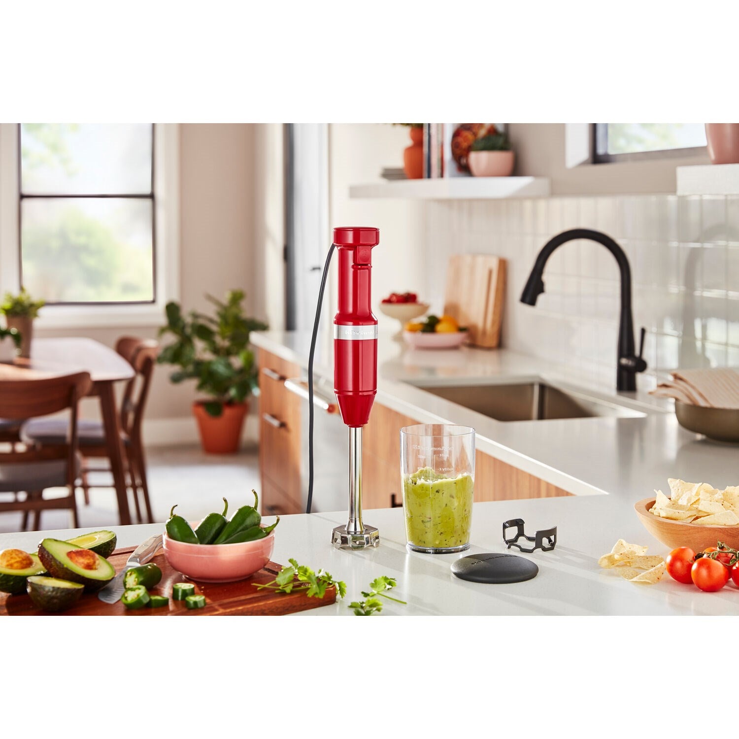 Empire red immersion blender blending in jar on kitchen countertop