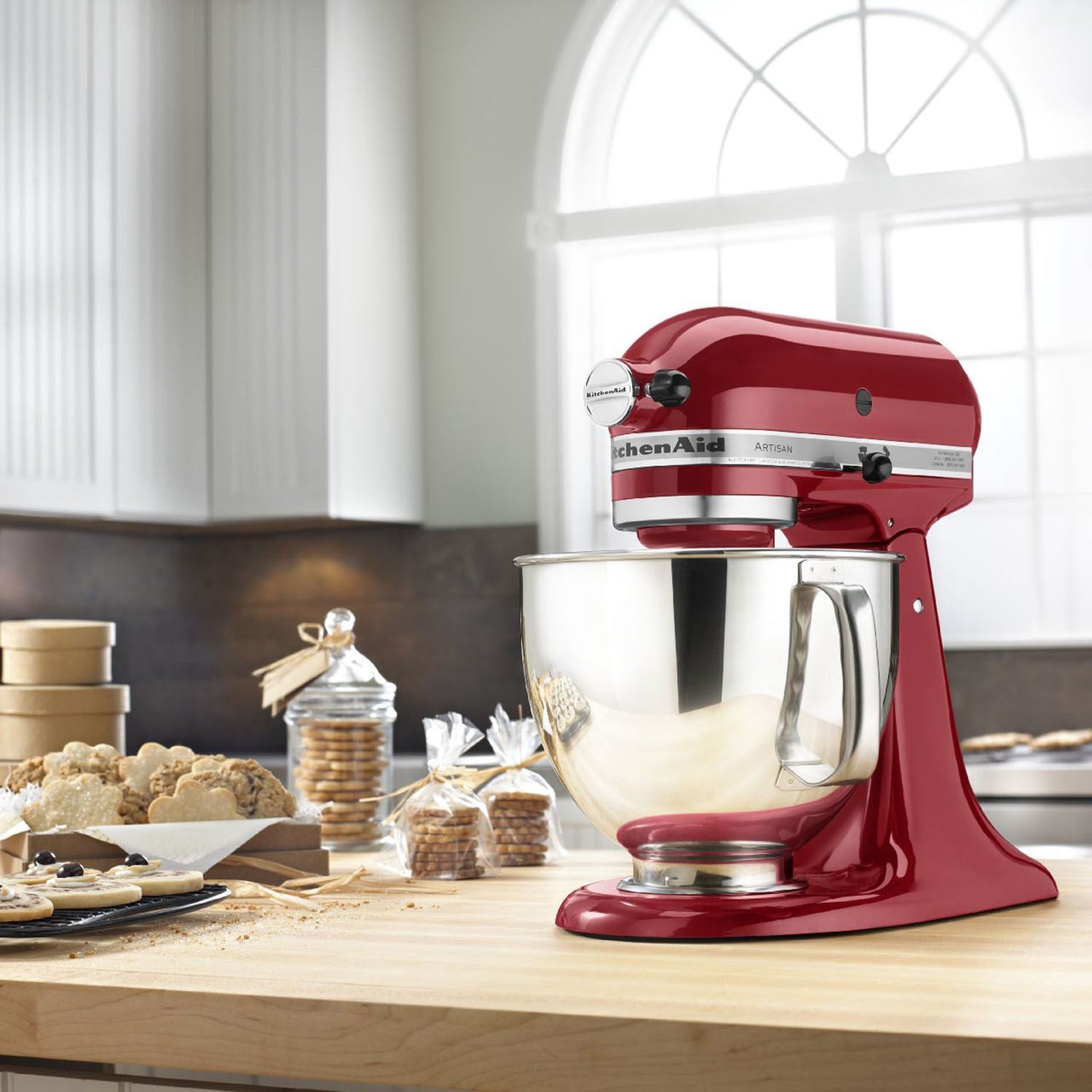Empire red KitchenAid tilt-head stand mixer on a countertop with stainless bowl