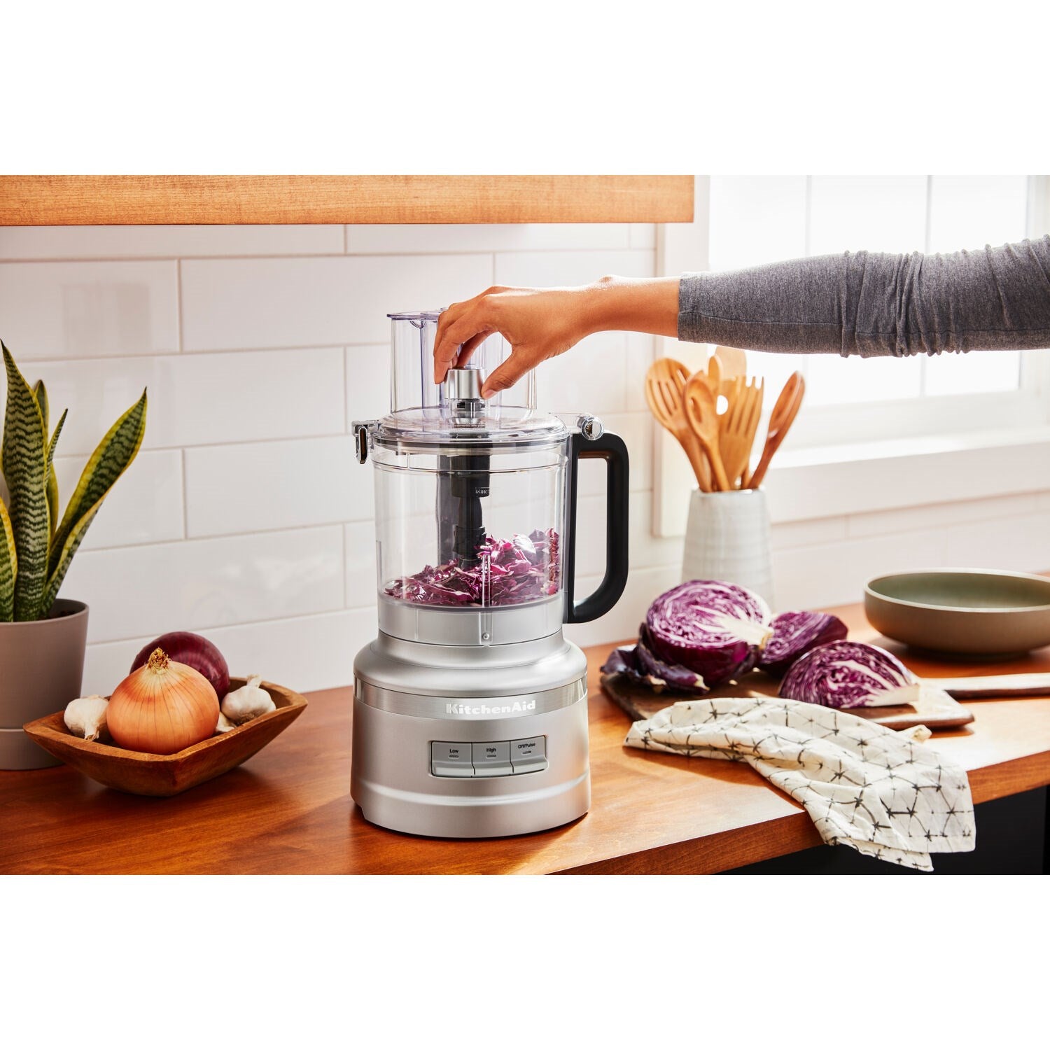 KitchenAid 13-cup food processor with clear work bowl, silver base, and black handle
