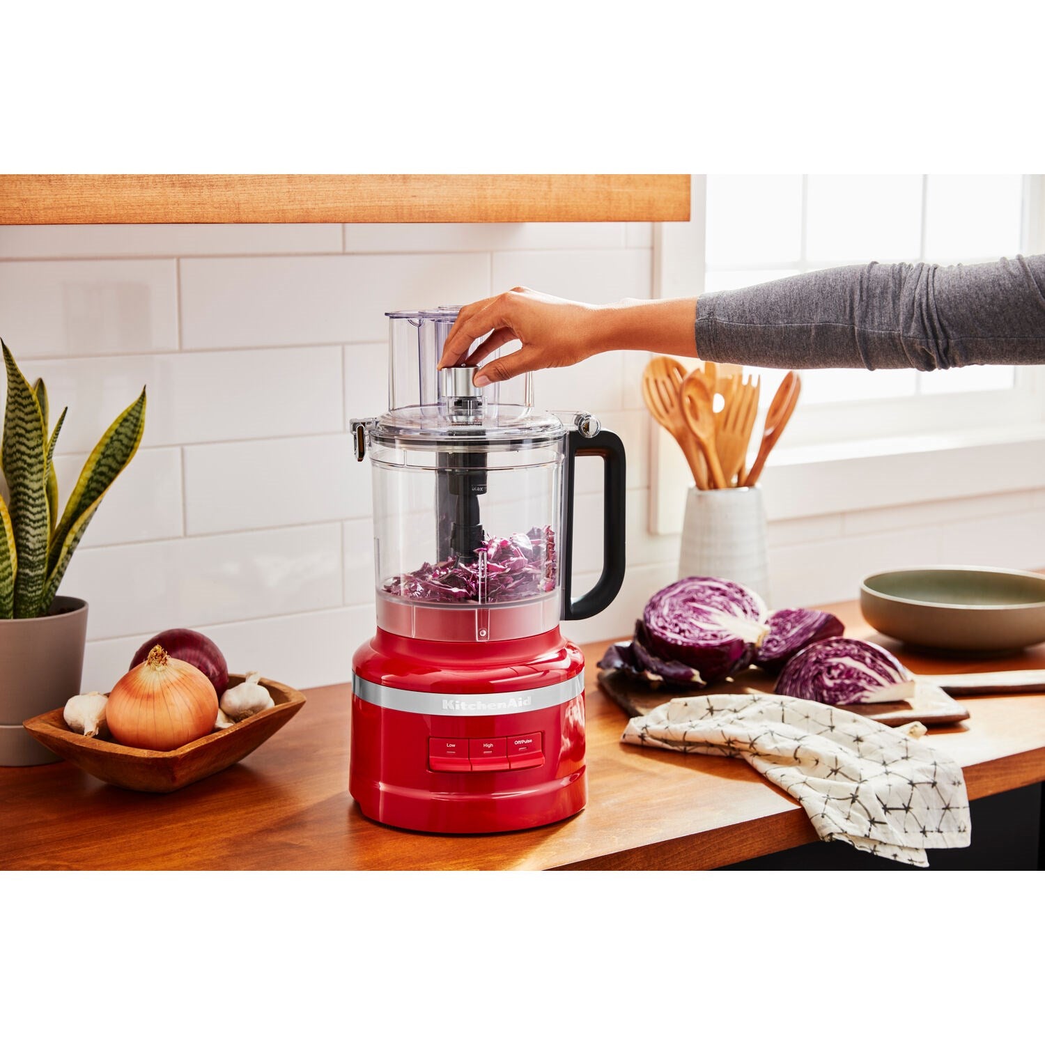 13-cup KitchenAid food processor in Empire Red with clear bowl on countertop