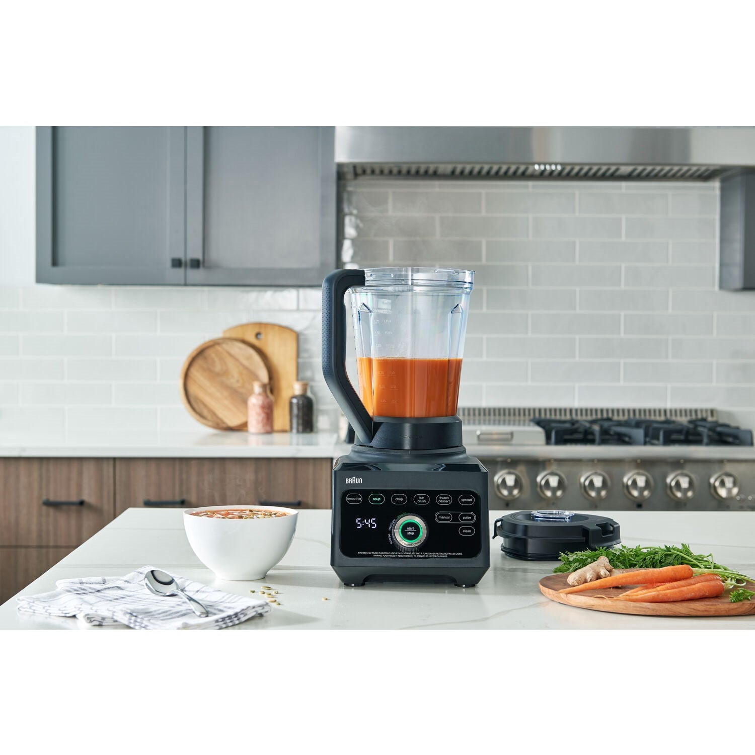 Black Braun blender with orange liquid in the clear jar