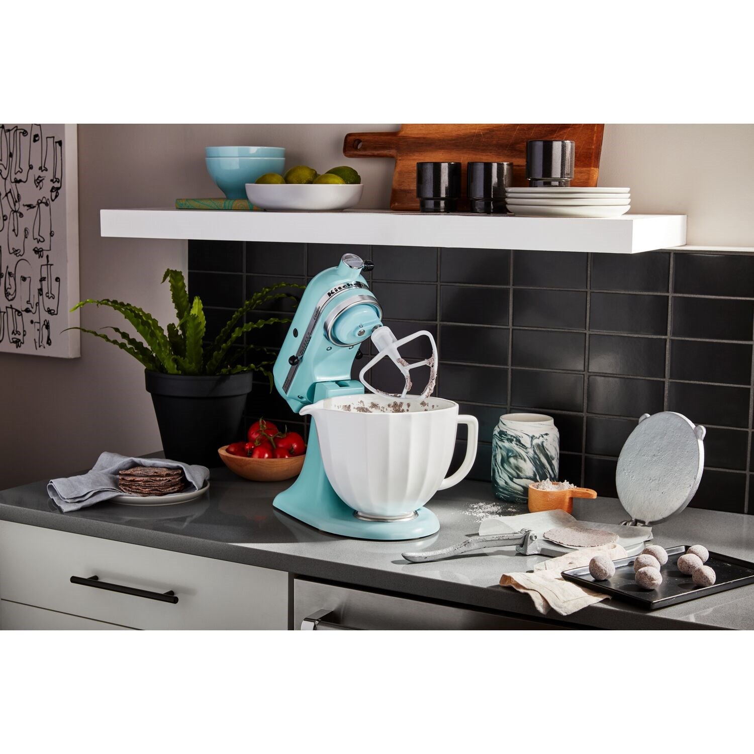 White ceramic mixing bowl on countertop with stand mixer nearby