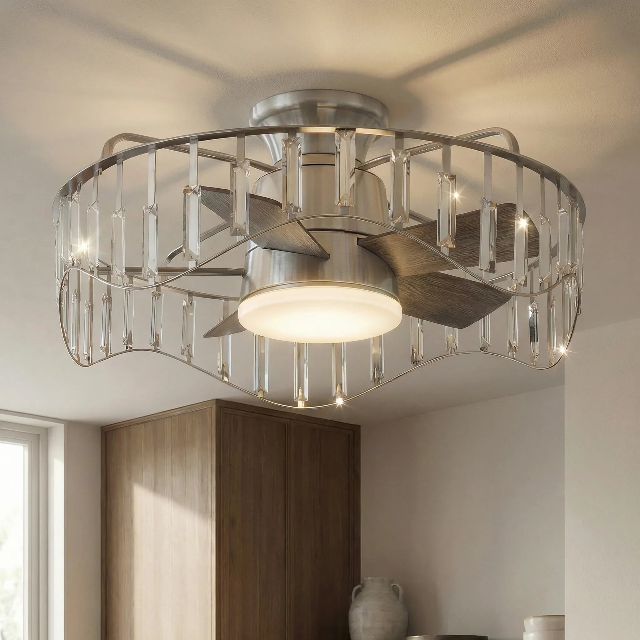 Brush nickel flush-mount ceiling fan with lit white diffuser, dark reversible blades, and clear cage