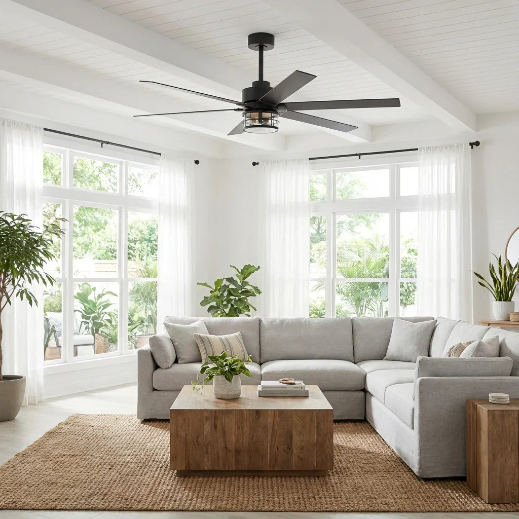 Black ceiling fan with light in a bright living room over a sectional sofa