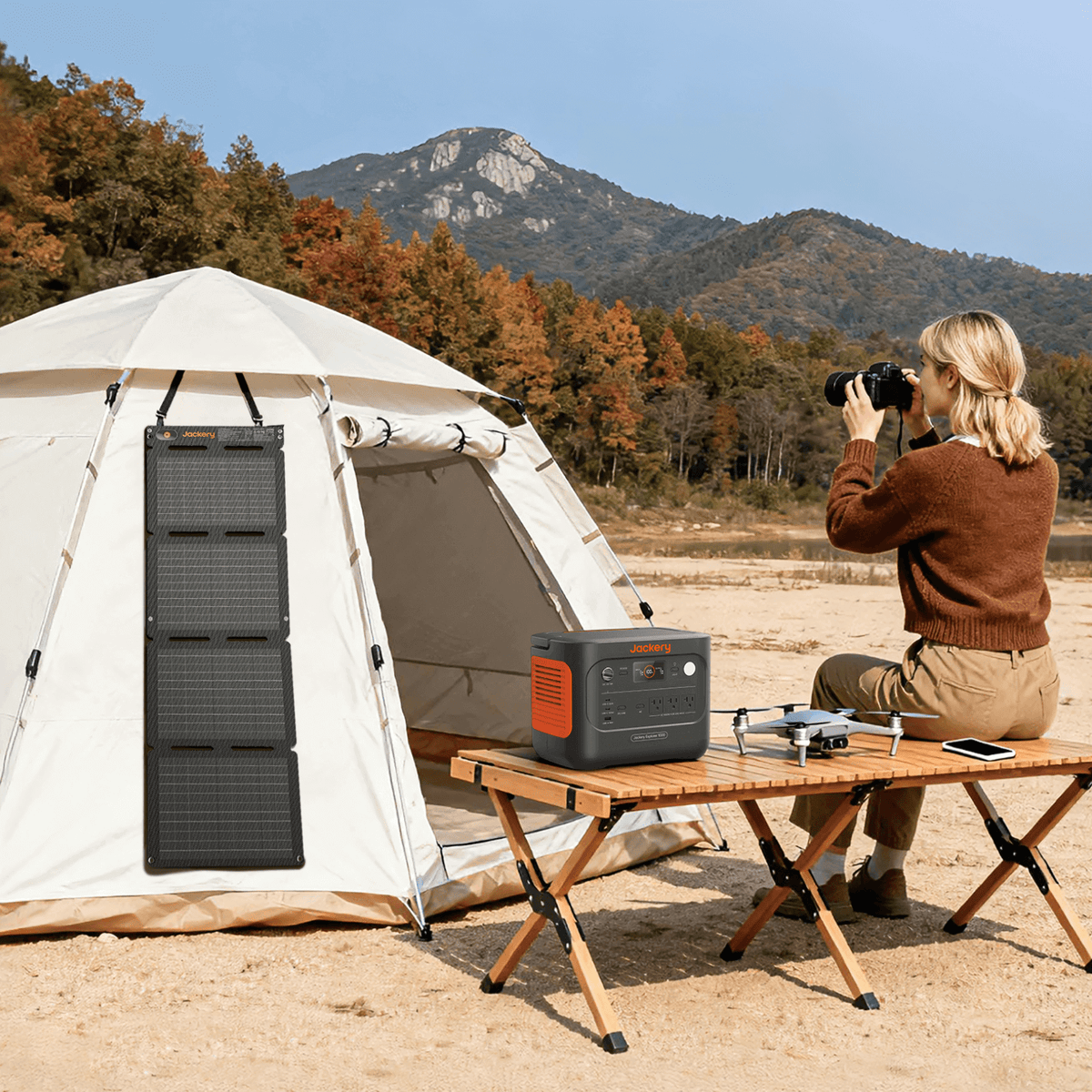 Foldable solar panel with four sections mounted to a tent setup, grid cells visible