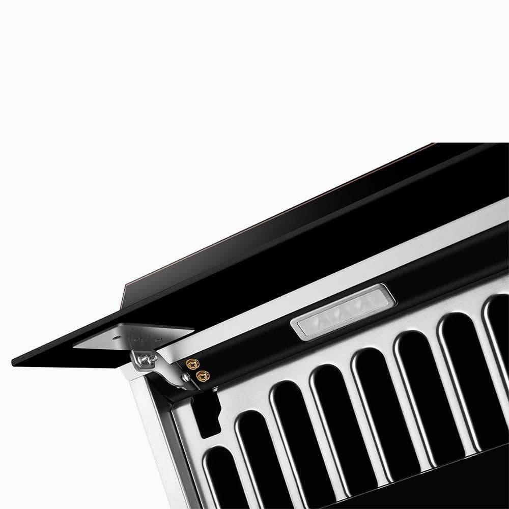 Close-up of onyx black range hood push buttons and vent openings