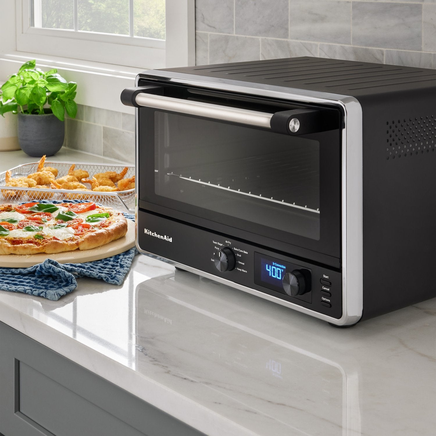 Black matte countertop oven with front door closed and digital display showing 400