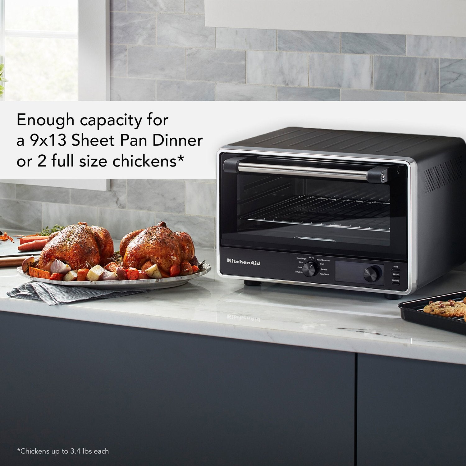 Black matte countertop oven on kitchen counter with large roasting space visible