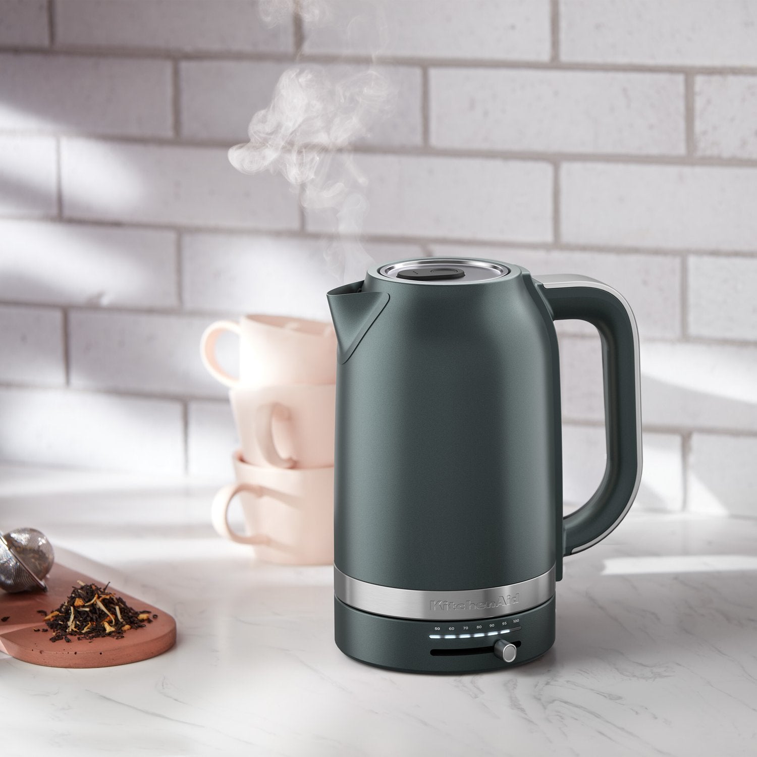 Juniper electric kettle on countertop with steam rising from the spout