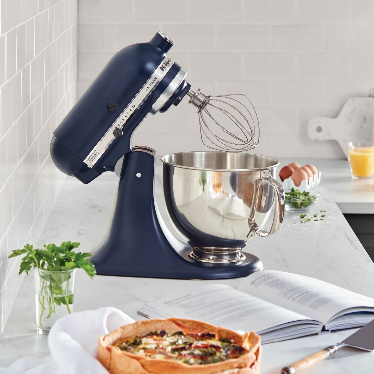 KitchenAid tilt-head stand mixer with whisk attachment and stainless bowl