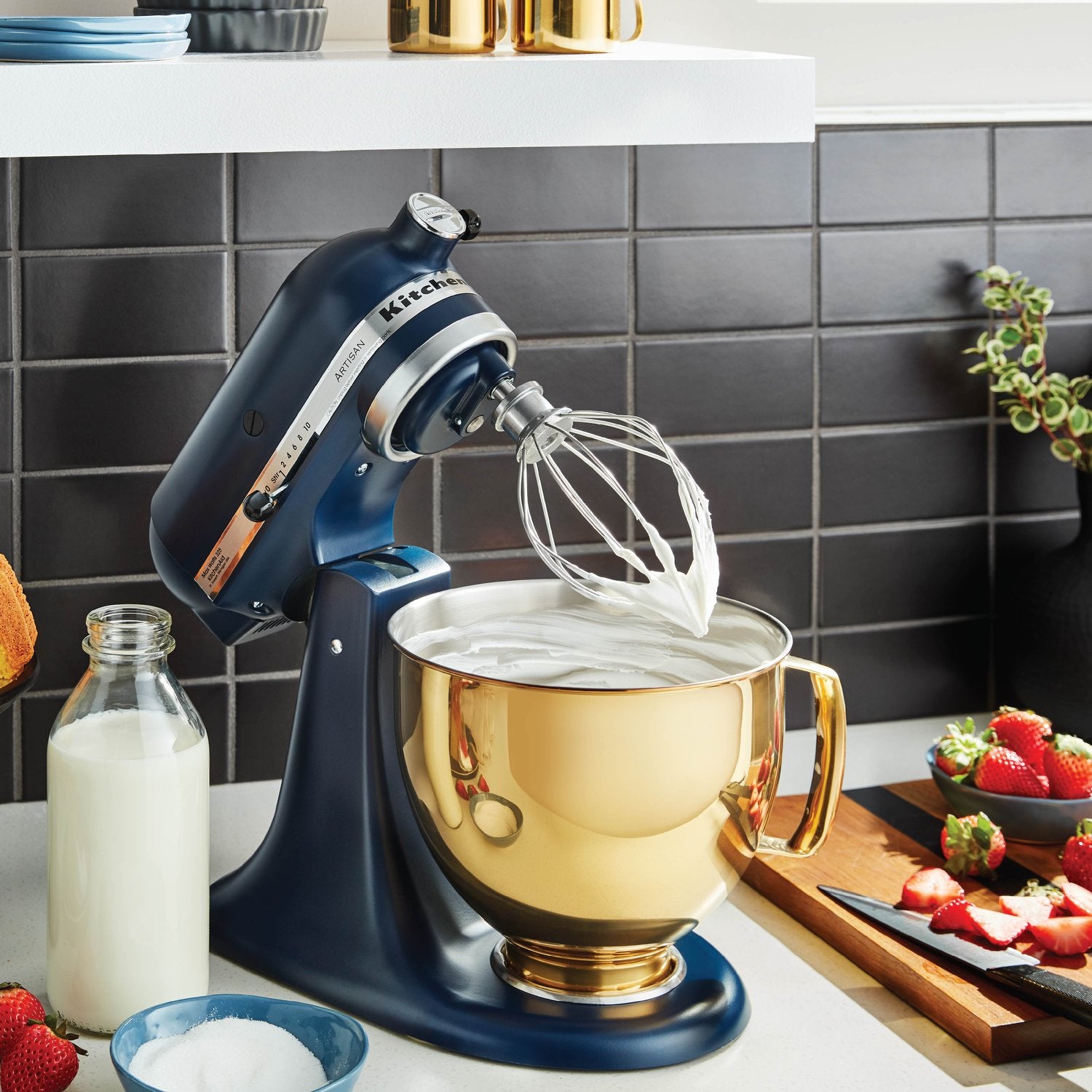 KitchenAid stand mixer with whisk attachment beating mixture in stainless bowl